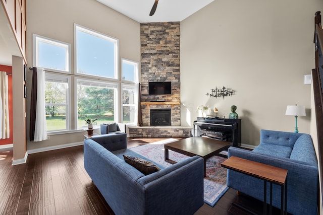816 Kelburn Ln, Pickerington, OH 43147 - living area with ceiling fan, a towering ceiling, a fireplace, baseboards, and dark wood-style flooring