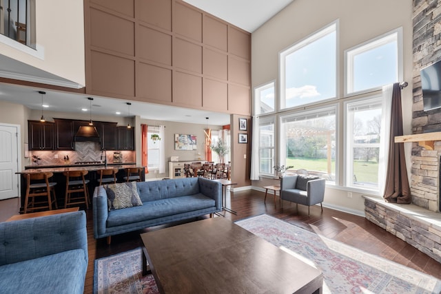 816 Kelburn Ln, Pickerington, OH 43147 - living area featuring dark wood-type flooring, a high ceiling, and baseboards