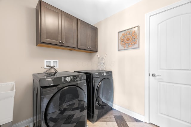 816 Kelburn Ln, Pickerington, OH 43147 - clothes washing area featuring washing machine and clothes dryer, light wood-style flooring, a sink, baseboards, and cabinet space