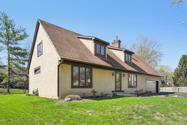 cape cod-style house with stucco siding, an attached garage, a chimney, and a front lawn