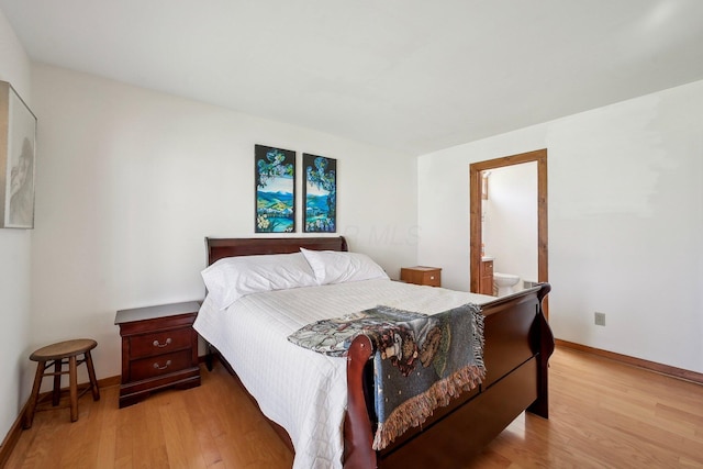 bedroom featuring light wood-type flooring, ensuite bath, and baseboards