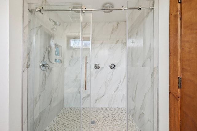 bathroom with a marble finish shower