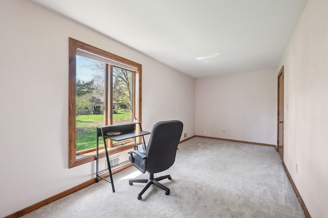 carpeted home office with baseboards