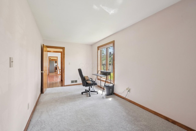 carpeted home office with baseboards and visible vents