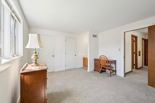 carpeted home office with baseboards and visible vents