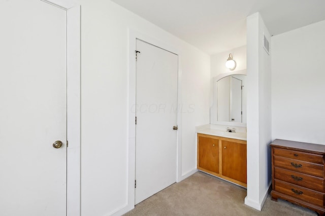 bathroom featuring baseboards, visible vents, and vanity