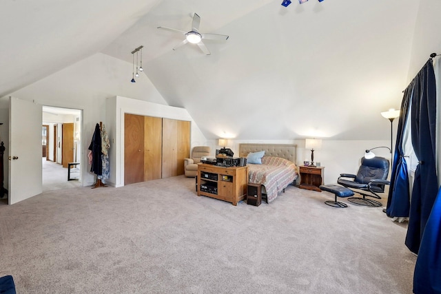 carpeted bedroom with vaulted ceiling, a closet, and ceiling fan