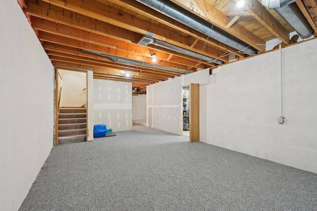 basement with stairway and concrete block wall