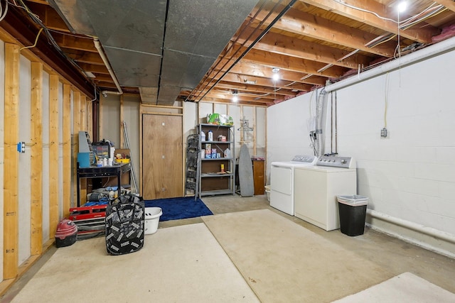 unfinished basement with washing machine and clothes dryer