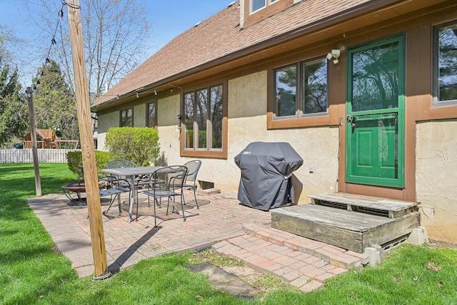 view of patio with outdoor dining area, area for grilling, and fence