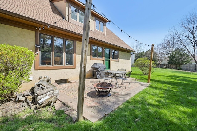 view of patio / terrace with a grill, an outdoor fire pit, and fence
