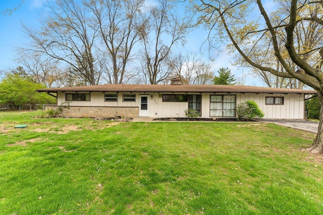 3434 Fishinger Rd, Columbus, OH 43221 - ranch-style home with a front lawn, board and batten siding, a chimney, and fence