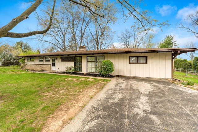 3434 Fishinger Rd, Columbus, OH 43221 - view of front facade featuring a front yard, driveway, a chimney, and fence
