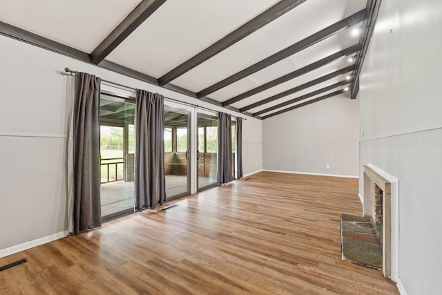3434 Fishinger Rd, Columbus, OH 43221 - unfurnished living room featuring lofted ceiling with beams, visible vents, light wood finished floors, and a fireplace