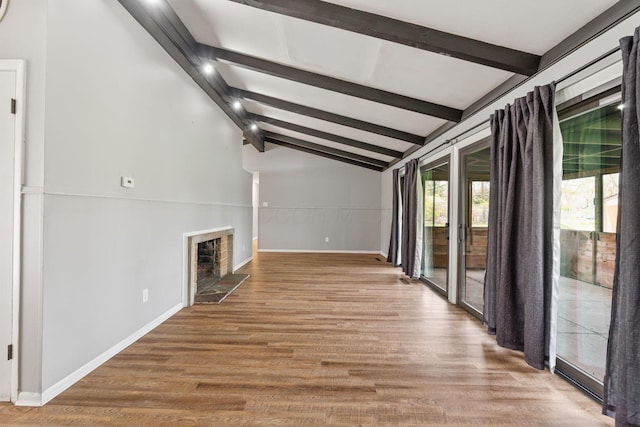 3434 Fishinger Rd, Columbus, OH 43221 - unfurnished living room with baseboards, vaulted ceiling with beams, wood finished floors, and a fireplace