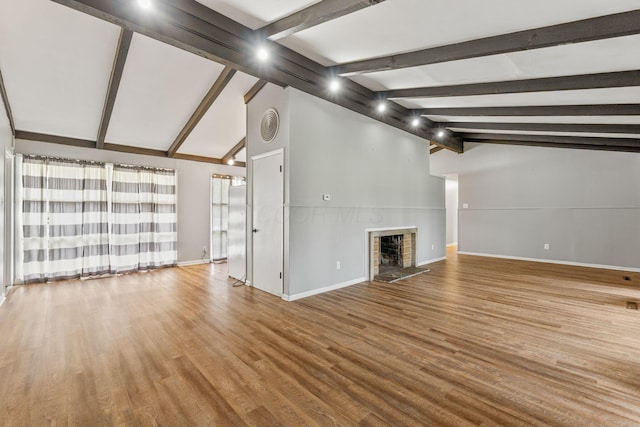3434 Fishinger Rd, Columbus, OH 43221 - unfurnished living room featuring baseboards, wood finished floors, vaulted ceiling with beams, and a fireplace with raised hearth