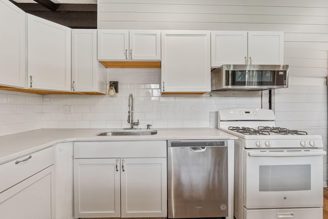 3434 Fishinger Rd, Columbus, OH 43221 - kitchen with white cabinets, appliances with stainless steel finishes, a sink, and light countertops