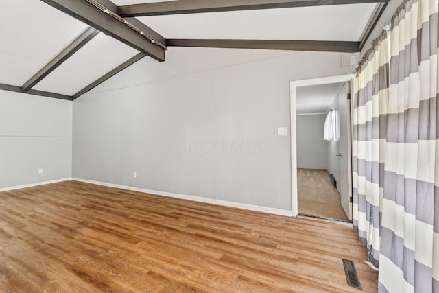 3434 Fishinger Rd, Columbus, OH 43221 - interior space featuring lofted ceiling with beams, baseboards, visible vents, and light wood-type flooring