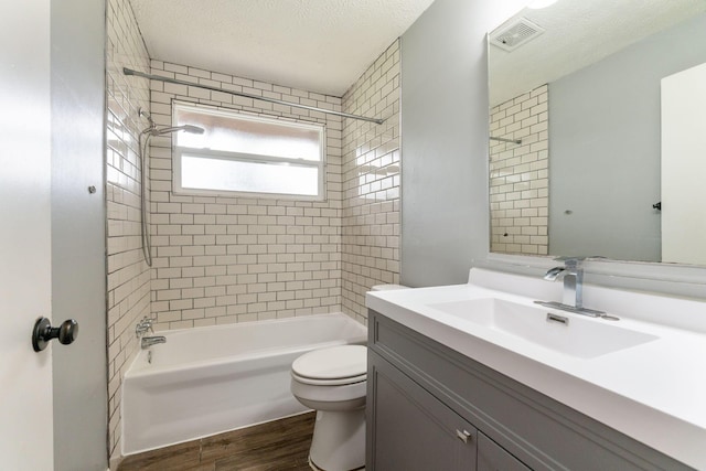 3434 Fishinger Rd, Columbus, OH 43221 - full bath featuring bathing tub / shower combination, wood finished floors, visible vents, toilet, and vanity