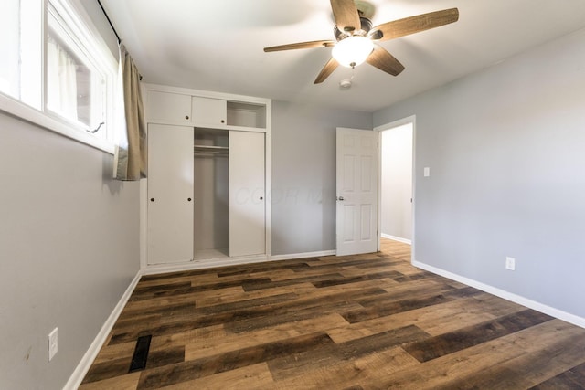 3434 Fishinger Rd, Columbus, OH 43221 - unfurnished bedroom with baseboards, a ceiling fan, dark wood-style floors, and a closet
