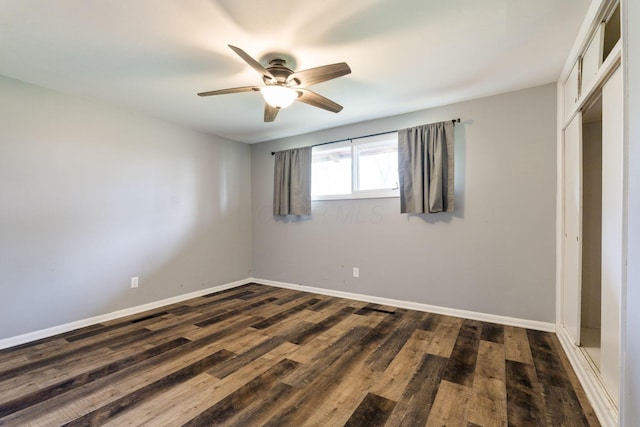 3434 Fishinger Rd, Columbus, OH 43221 - unfurnished bedroom featuring dark wood finished floors, a closet, baseboards, and ceiling fan