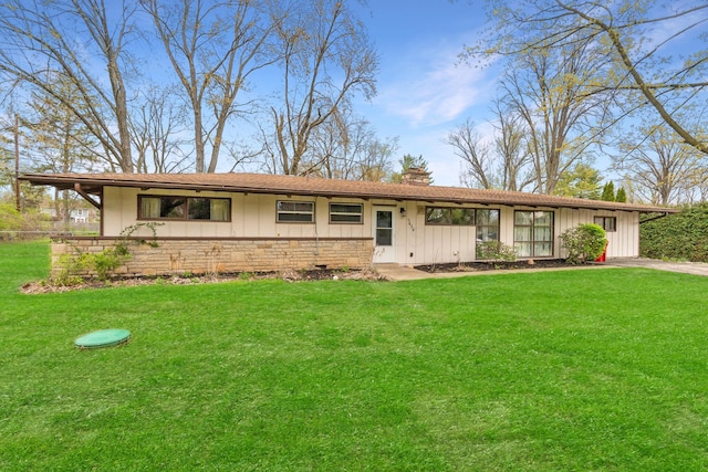 3434 Fishinger Rd, Columbus, OH 43221 - ranch-style house with board and batten siding, stone siding, a chimney, and a front yard
