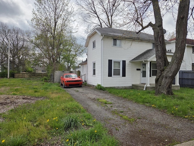 view of front of house featuring aphalt driveway and fence