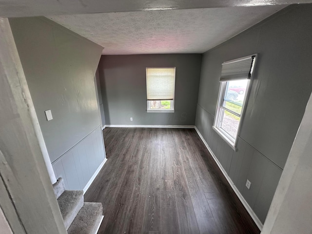 2969 E 11th Ave, Columbus, OH 43219 - empty room featuring a textured ceiling, wood finished floors, a wainscoted wall, baseboards, and stairway