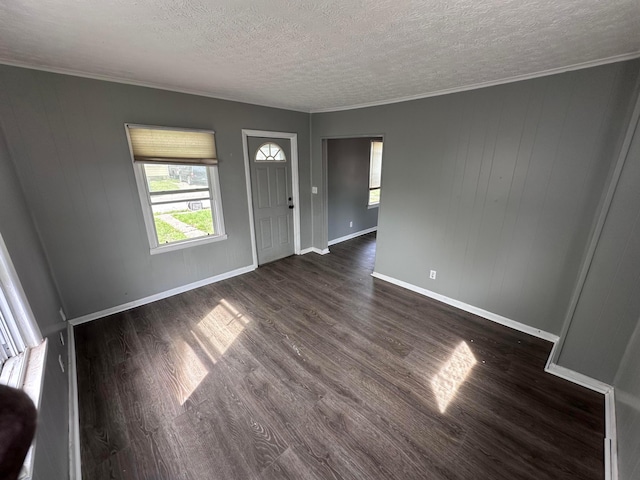 2969 E 11th Ave, Columbus, OH 43219 - entryway featuring plenty of natural light, a textured ceiling, dark wood-style floors, ornamental molding, and baseboards