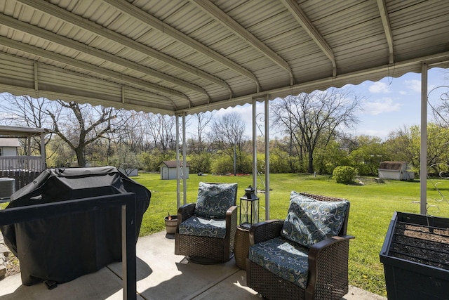 view of patio featuring a storage unit, an outdoor structure, and area for grilling