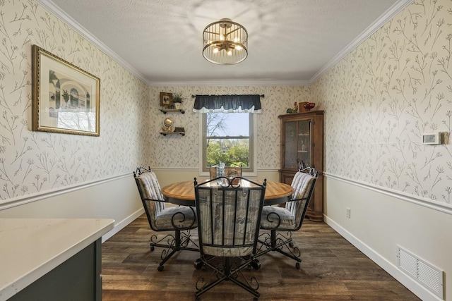 dining area featuring dark wood finished floors, visible vents, a notable chandelier, wallpapered walls, and ornamental molding