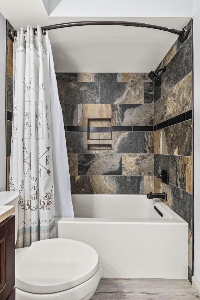 full bath featuring vanity, wood finished floors, shower / bathtub combination with curtain, and toilet