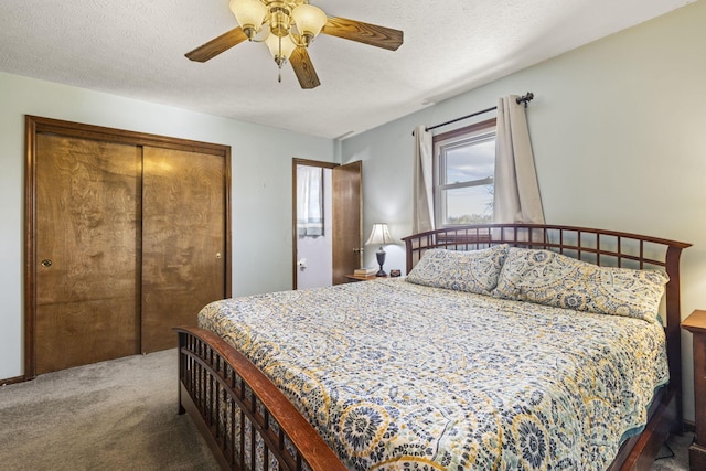 carpeted bedroom with a textured ceiling, a closet, and ceiling fan