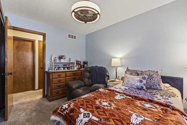 carpeted bedroom featuring visible vents