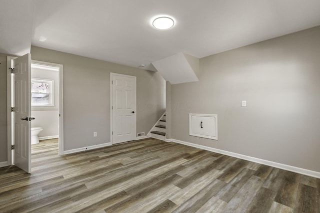 bonus room with baseboards, wood finished floors, visible vents, and stairs