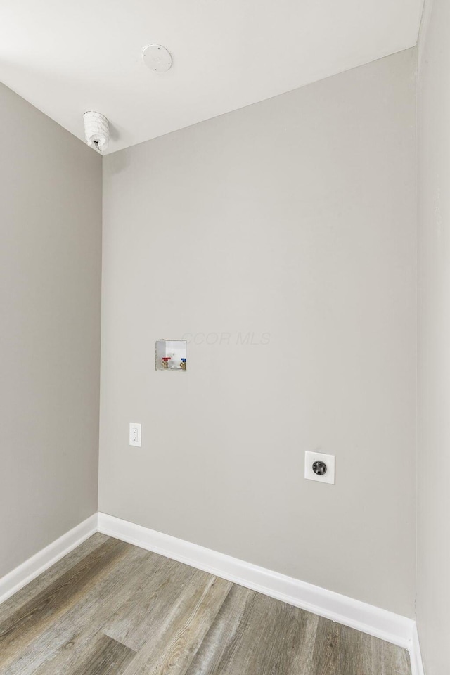 laundry room featuring hookup for an electric dryer, baseboards, hookup for a washing machine, wood finished floors, and laundry area