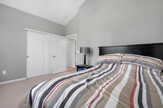 carpeted bedroom with baseboards, high vaulted ceiling, and a closet