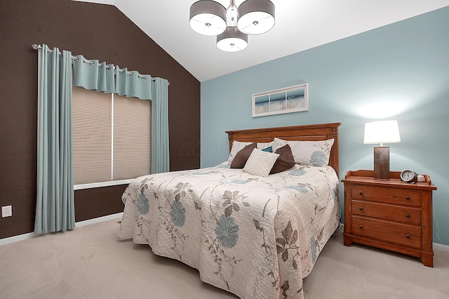 bedroom featuring a chandelier, carpet, lofted ceiling, and baseboards