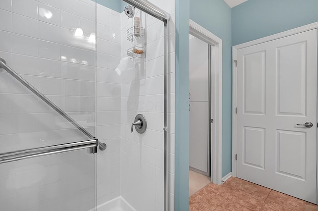 full bathroom with a shower stall and tile patterned flooring