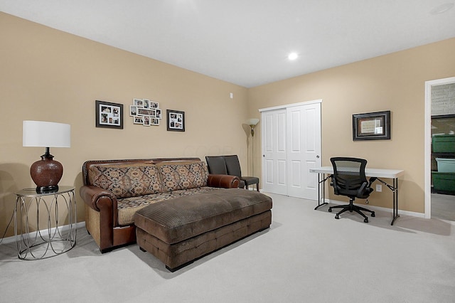 carpeted living area with baseboards and recessed lighting