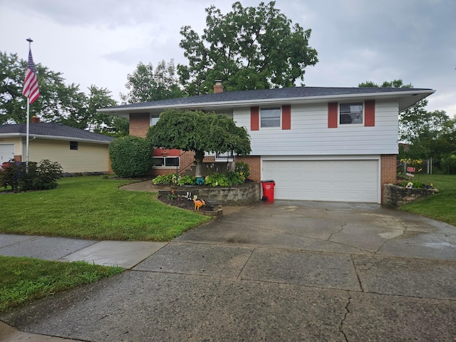 3890 Tamara Dr, Grove City, OH 43123 - split foyer home featuring brick siding, a garage, concrete driveway, a front lawn, and a chimney