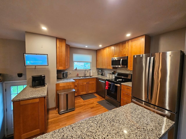 3890 Tamara Dr, Grove City, OH 43123 - kitchen with stainless steel appliances, light wood-style floors, tasteful backsplash, light stone countertops, and recessed lighting