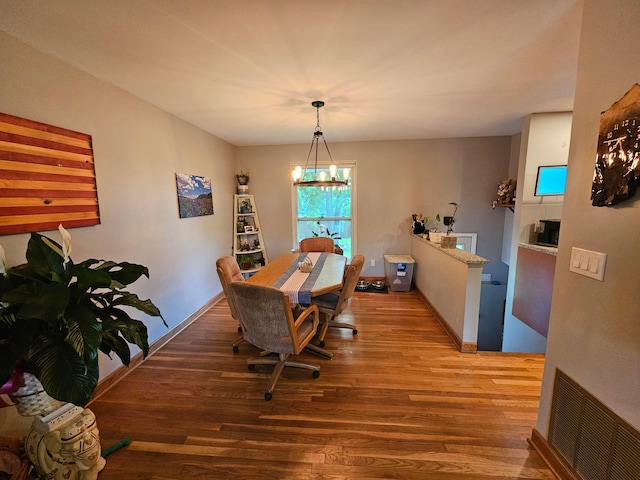 3890 Tamara Dr, Grove City, OH 43123 - dining room featuring wood finished floors and a chandelier