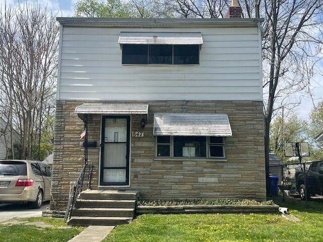 847 S Eureka Ave, Columbus, OH 43204 - view of front of home with stone siding and a chimney