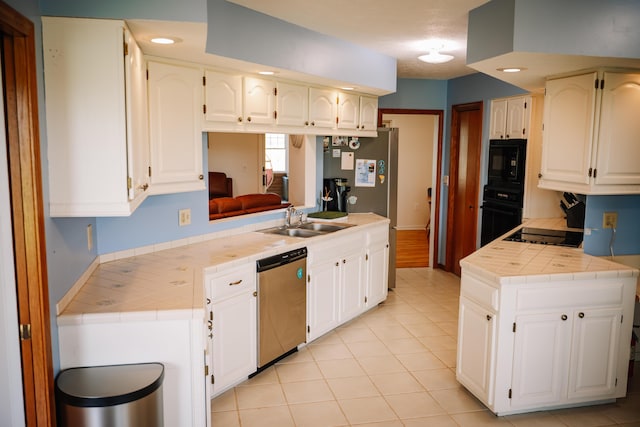 17920 Miller Rd, Richwood, OH 43344 - kitchen with a sink, white cabinetry, black appliances, tile countertops, and light tile patterned floors