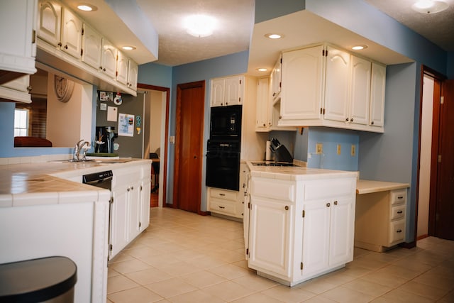 17920 Miller Rd, Richwood, OH 43344 - kitchen with tile counters, light tile patterned floors, a sink, and black appliances