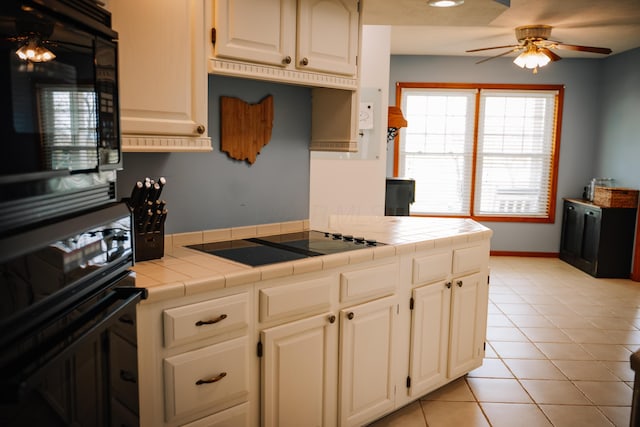 17920 Miller Rd, Richwood, OH 43344 - kitchen featuring black appliances, tile counters, ceiling fan, and light tile patterned floors
