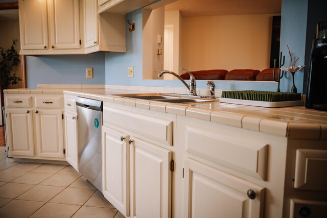 17920 Miller Rd, Richwood, OH 43344 - kitchen featuring light tile patterned floors, tile countertops, stainless steel dishwasher, and a sink