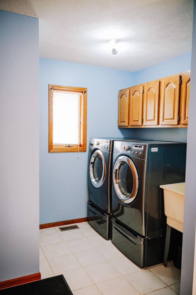 17920 Miller Rd, Richwood, OH 43344 - laundry room with washing machine and clothes dryer, a textured ceiling, baseboards, visible vents, and cabinet space