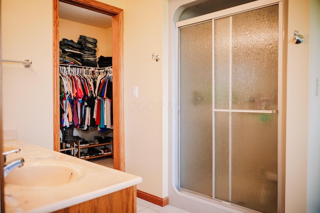 17920 Miller Rd, Richwood, OH 43344 - full bathroom featuring tile patterned floors, a sink, a walk in closet, and a stall shower